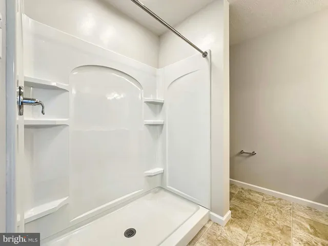 a bathroom with a shower and a sink