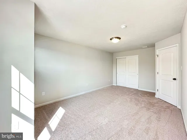 a view of a big room with windows and chandelier fan