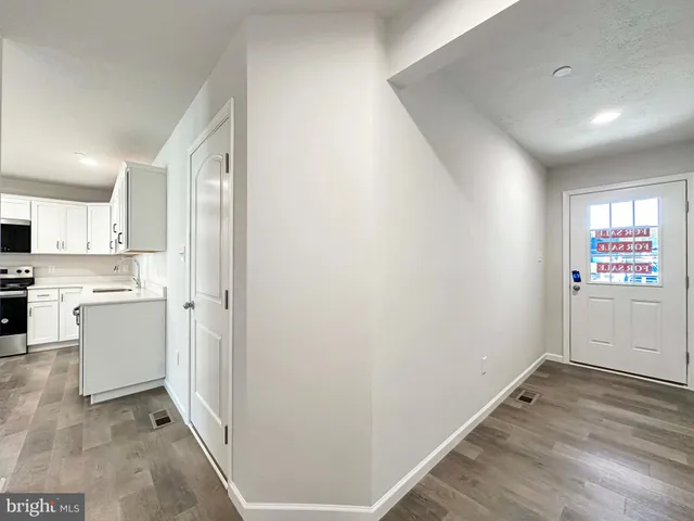 a view of a kitchen with white cabinets