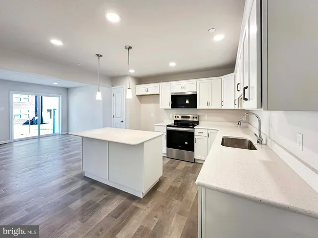 a kitchen with a sink a microwave and cabinets