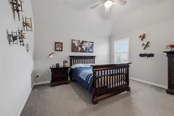 a bed room with a bed and a chandelier
