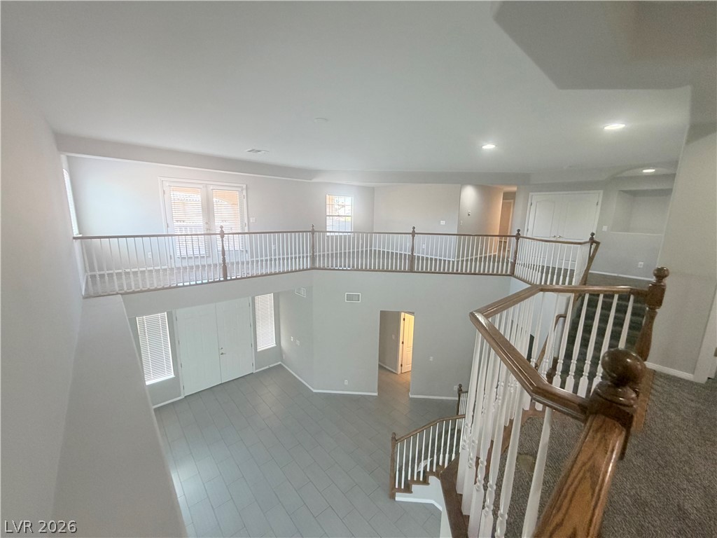 6116 Rabbit Track Street Las Vegas, NV 89130 - Photo 28 of 28 An airy, sun-filled interior showcases an inviting open floorplan and a grand staircase.