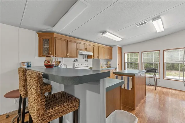 a living room with furniture a wooden floor and a window