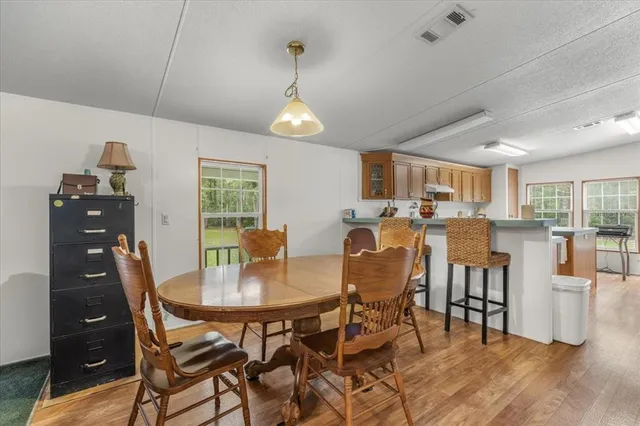 a view of a dining room with furniture and wooden floor