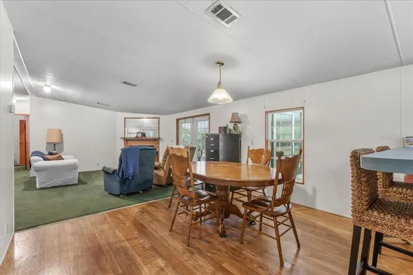 a dining room with furniture and window