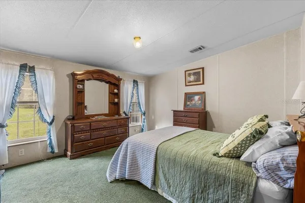 a bedroom with a bed and a dresser
