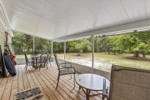 a view of a patio with a dining table and chairs