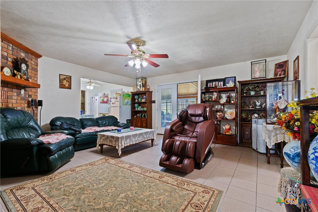 3037 Boys Ranch Road Kempner, TX 76539 - Photo 11 of 47 a living room with furniture a rug and a chandelier
