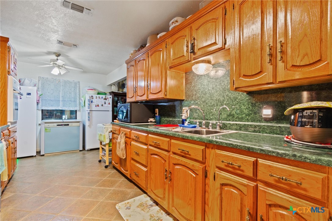 3037 Boys Ranch Road Kempner, TX 76539 - Photo 17 of 47 a kitchen with stainless steel appliances granite countertop a sink and cabinets