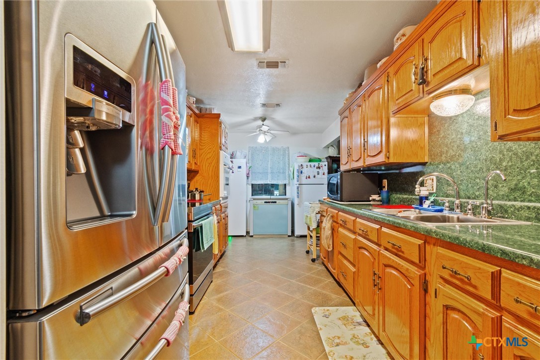 3037 Boys Ranch Road Kempner, TX 76539 - Photo 18 of 47 a kitchen with stainless steel appliances a refrigerator and a stove