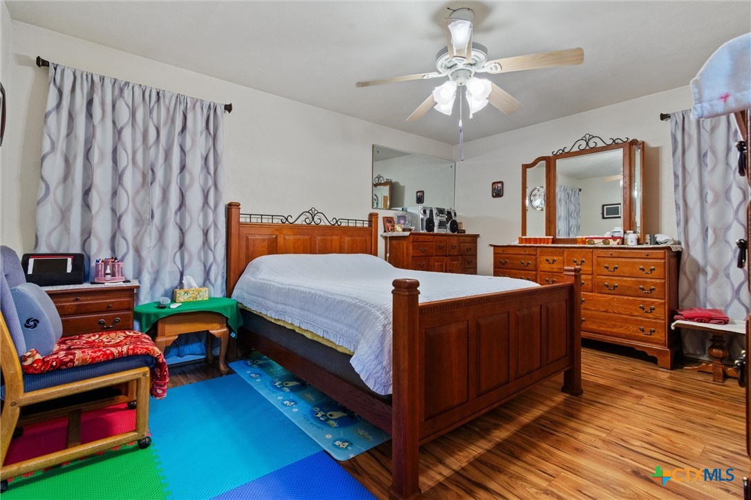 3037 Boys Ranch Road Kempner, TX 76539 - Photo 21 of 47 a bedroom with a bed and a chandelier