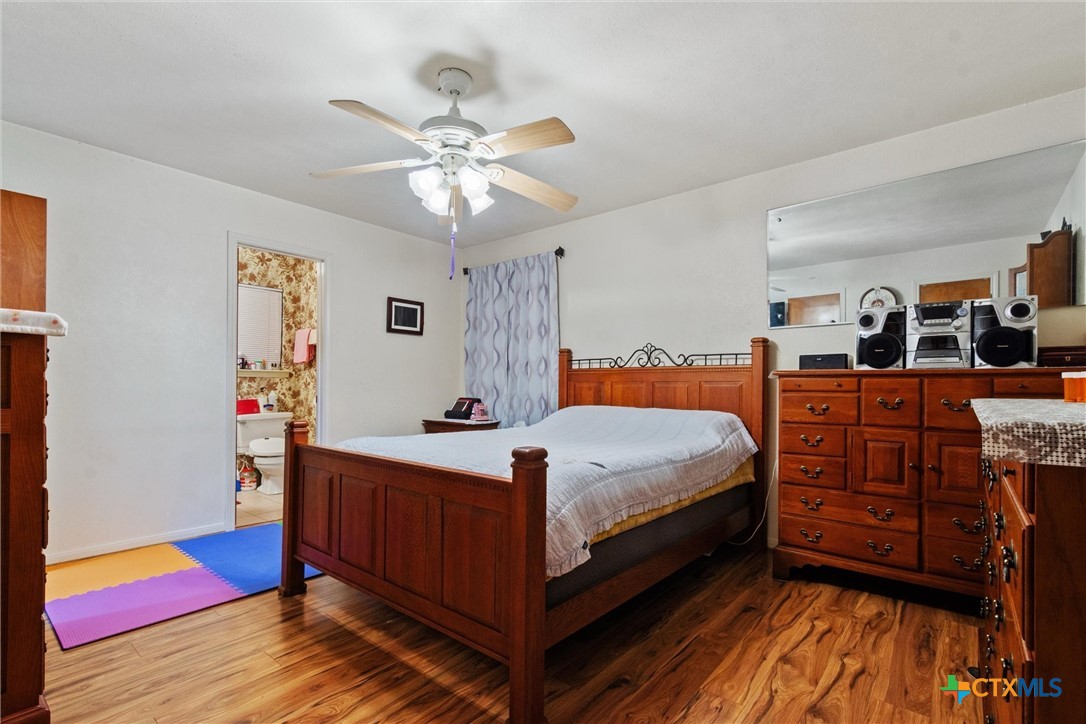 3037 Boys Ranch Road Kempner, TX 76539 - Photo 22 of 47 a bedroom with a bed and a chandelier