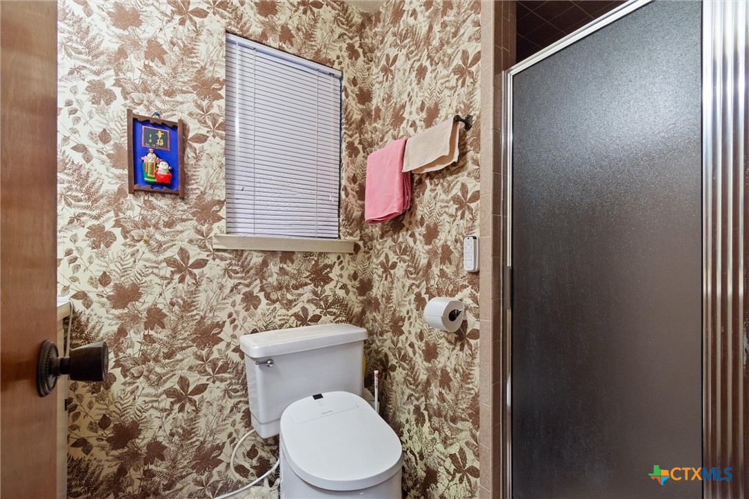 3037 Boys Ranch Road Kempner, TX 76539 - Photo 31 of 47 a bathroom with a toilet and a shower curtain