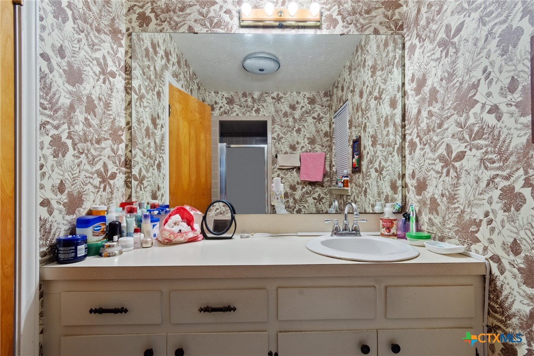 3037 Boys Ranch Road Kempner, TX 76539 - Photo 34 of 47 a bathroom with a sink and a mirror