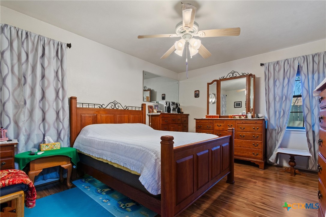 3037 Boys Ranch Road Kempner, TX 76539 - Photo 36 of 47 a bed room with a bed and a chandelier