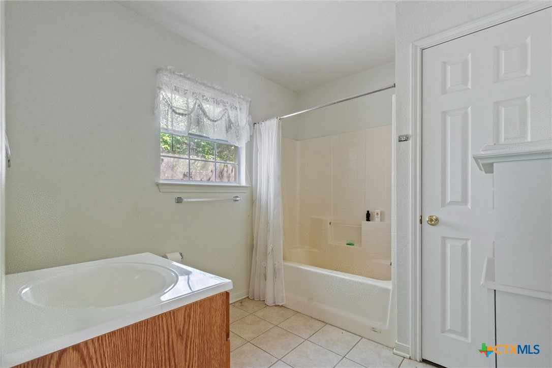 3037 Boys Ranch Road Kempner, TX 76539 - Photo 38 of 47 a bathroom with a tub a sink and a shower