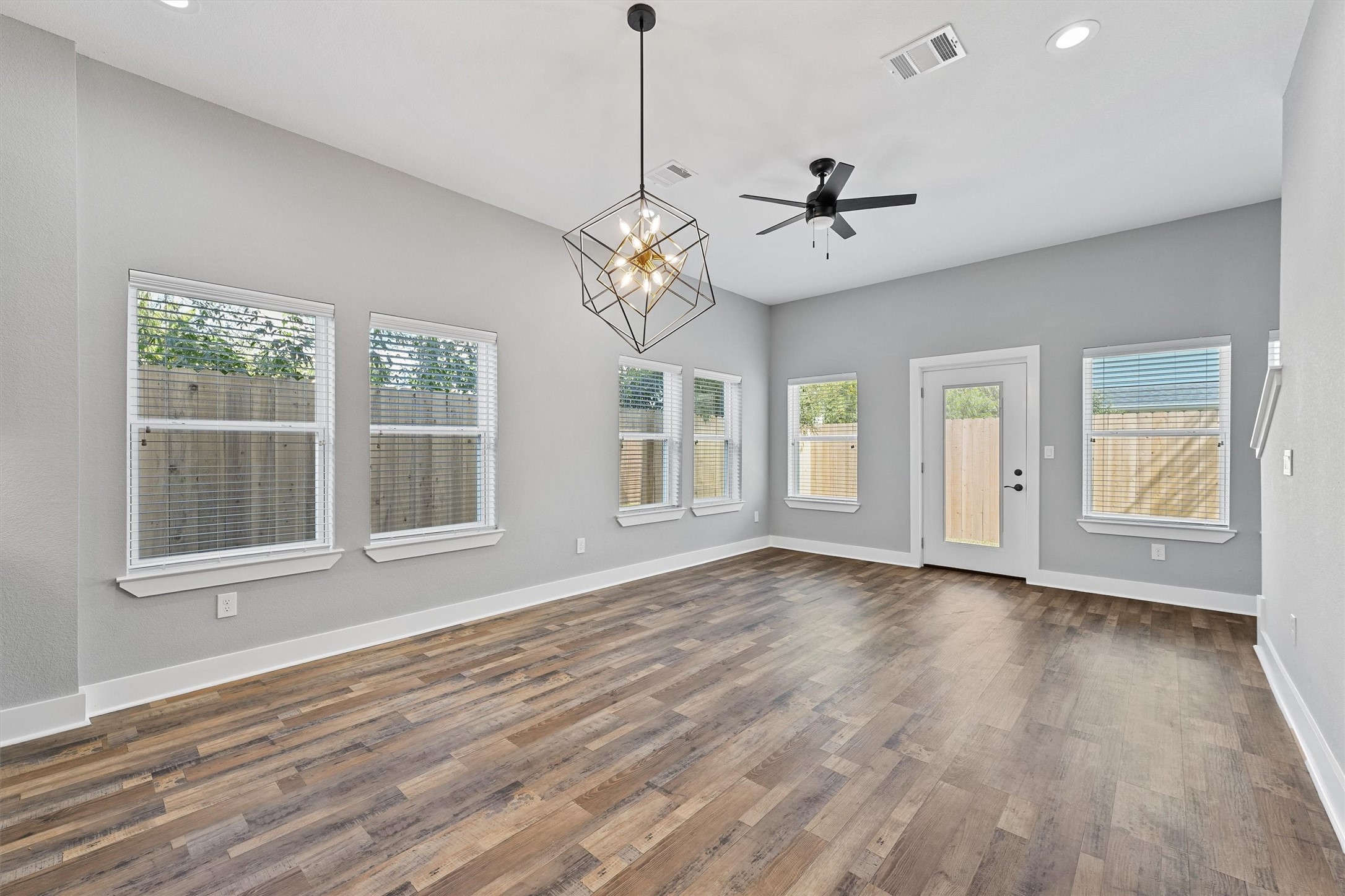 7704 Sealey Street Houston, TX 77088 - Photo 5 of 15 a view of an empty room with wooden floor and a window