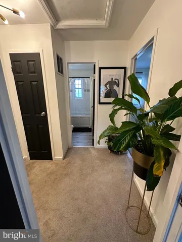 a view of a hallway with paintings on the wall