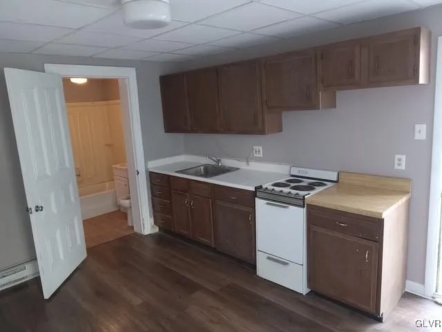 a kitchen with a sink a stove and cabinets