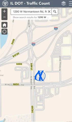 a front view of a house with a yard and fountain in the back