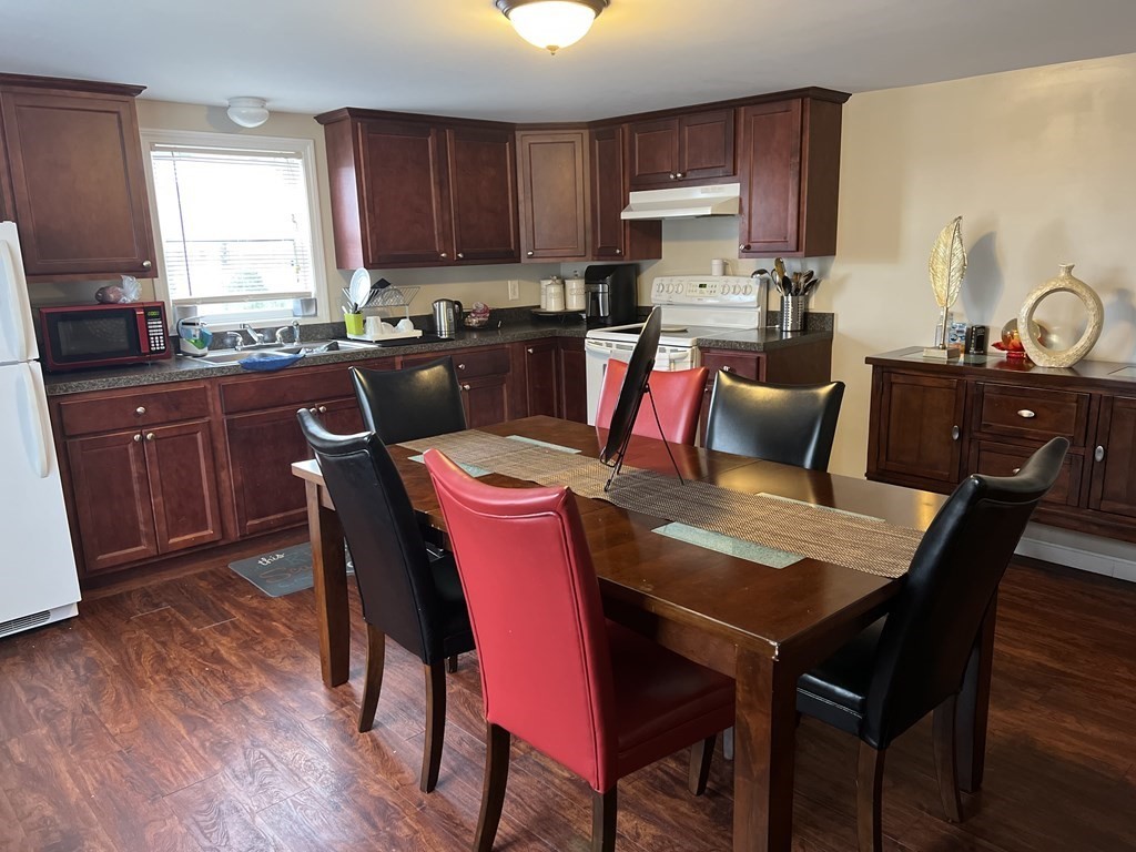 63 Brow Street Fall River, MA 02721 - Photo 11 of 35 a kitchen with a wooden table and chairs