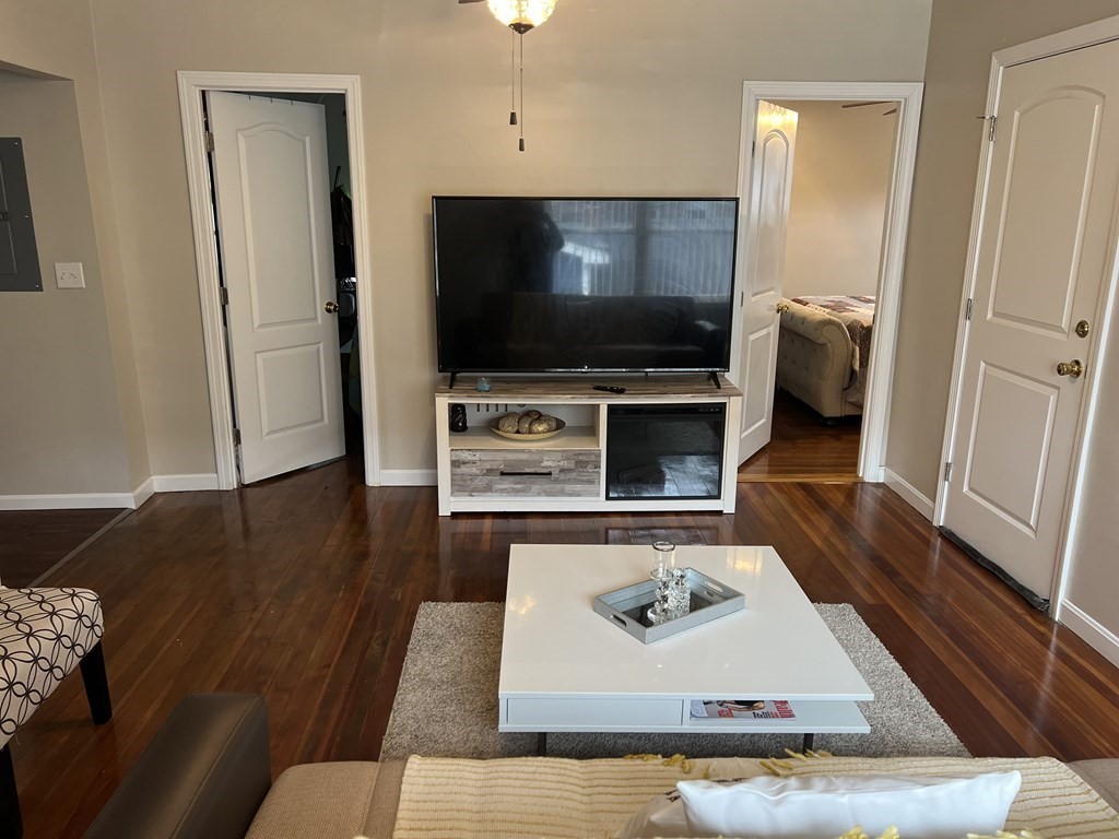 63 Brow Street Fall River, MA 02721 - Photo 16 of 35 a living room with furniture and a flat screen tv