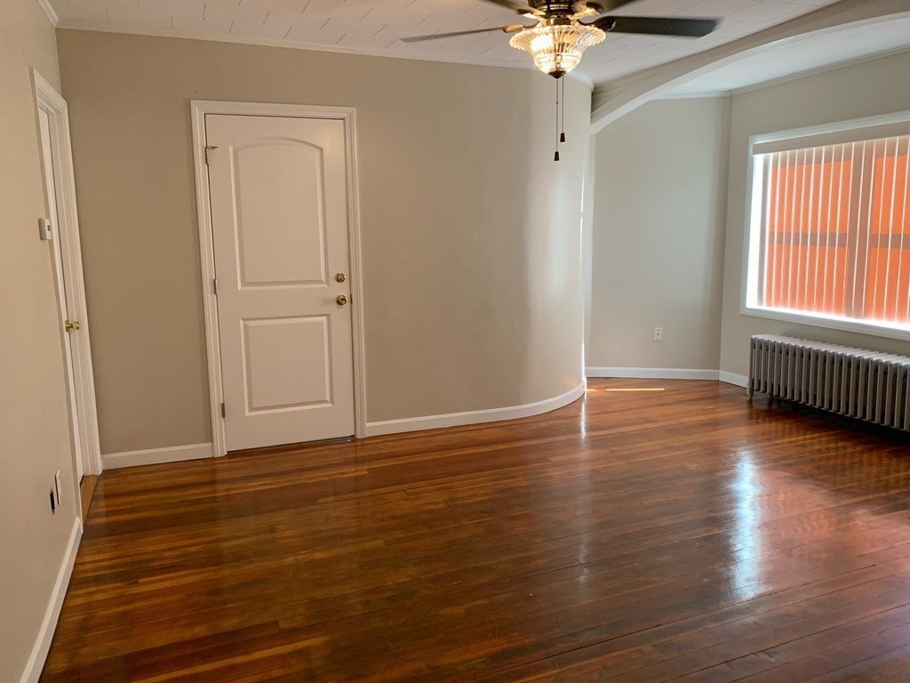 63 Brow Street Fall River, MA 02721 - Photo 22 of 35 a view of an empty room with wooden floor and a window