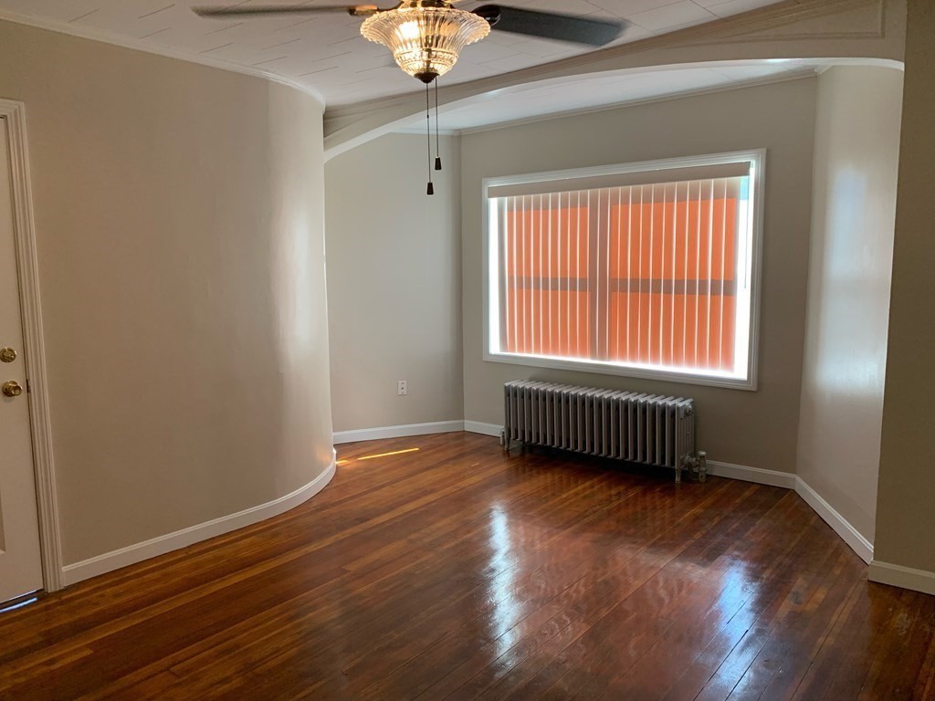63 Brow Street Fall River, MA 02721 - Photo 24 of 35 a view of an empty room with wooden floor and a window