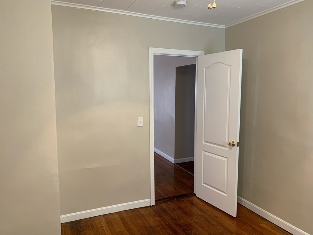 63 Brow Street Fall River, MA 02721 - Photo 25 of 35 an empty room with wooden floor and closet