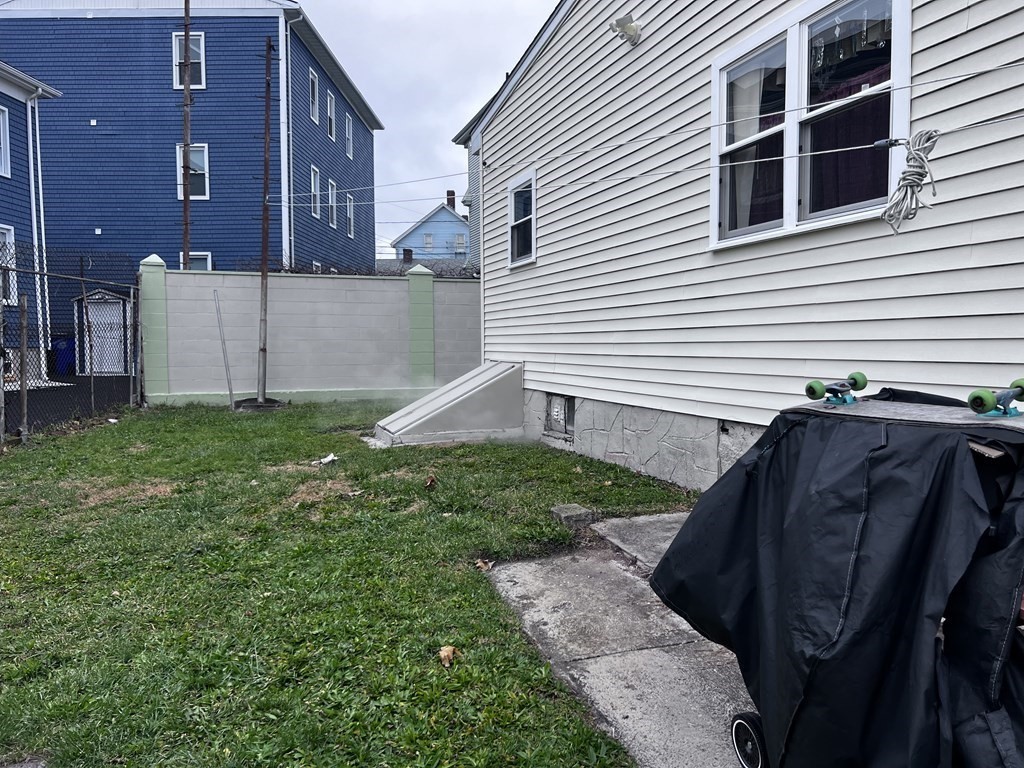 63 Brow Street Fall River, MA 02721 - Photo 33 of 35 a view of backyard with barbeque grill and wooden fence