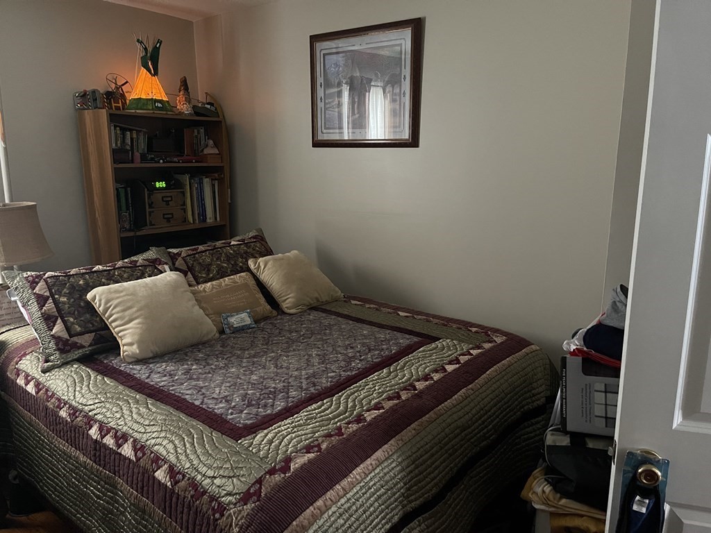 63 Brow Street Fall River, MA 02721 - Photo 8 of 35 a bed sitting in a bedroom next to a cabinet