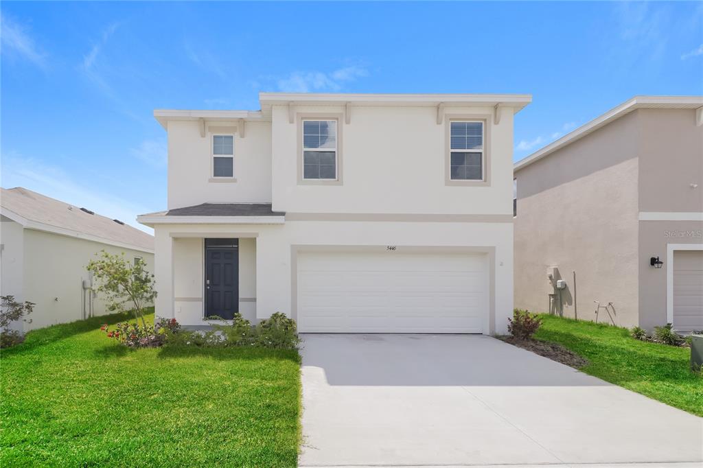 5446 Oxford Gray Road Wesley Chapel, FL 33545 - Photo 1 of 1 a front view of house with a garden