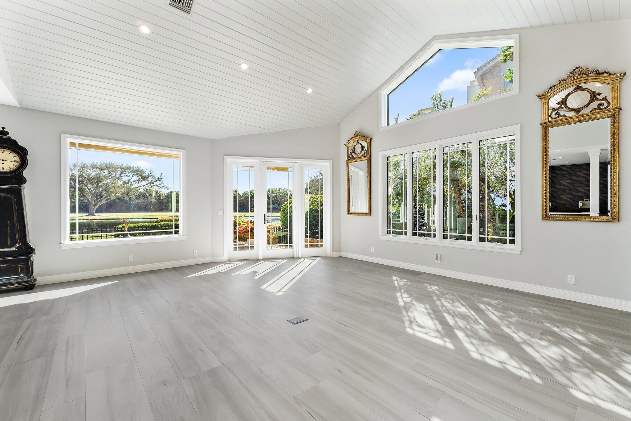 12092 Southeast Birkdale Run Jupiter, FL 33469 - Photo 11 of 53 a view of an empty room with wooden floor and a window