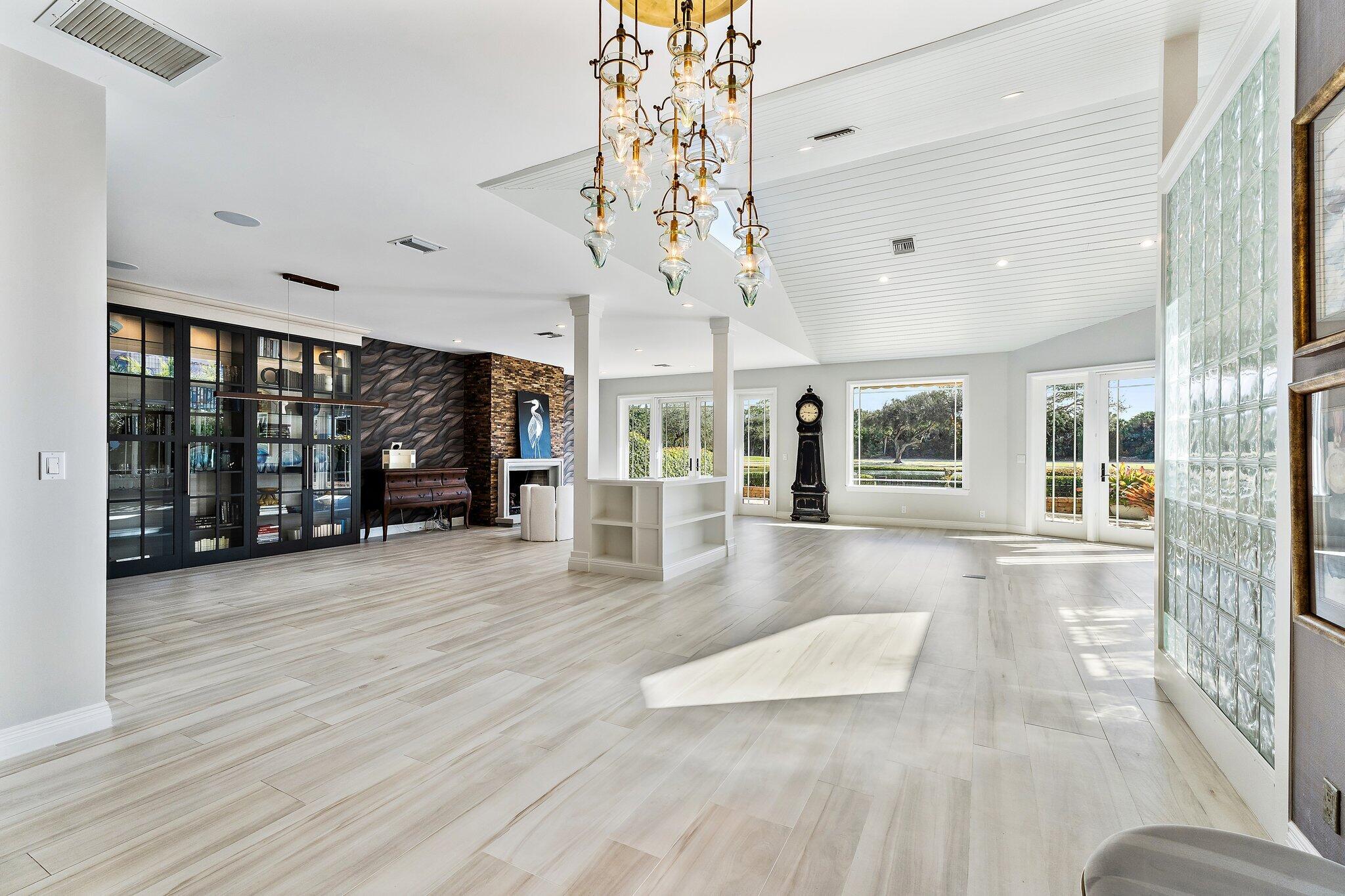 12092 Southeast Birkdale Run Jupiter, FL 33469 - Photo 16 of 53 an empty room with wooden floor and large windows