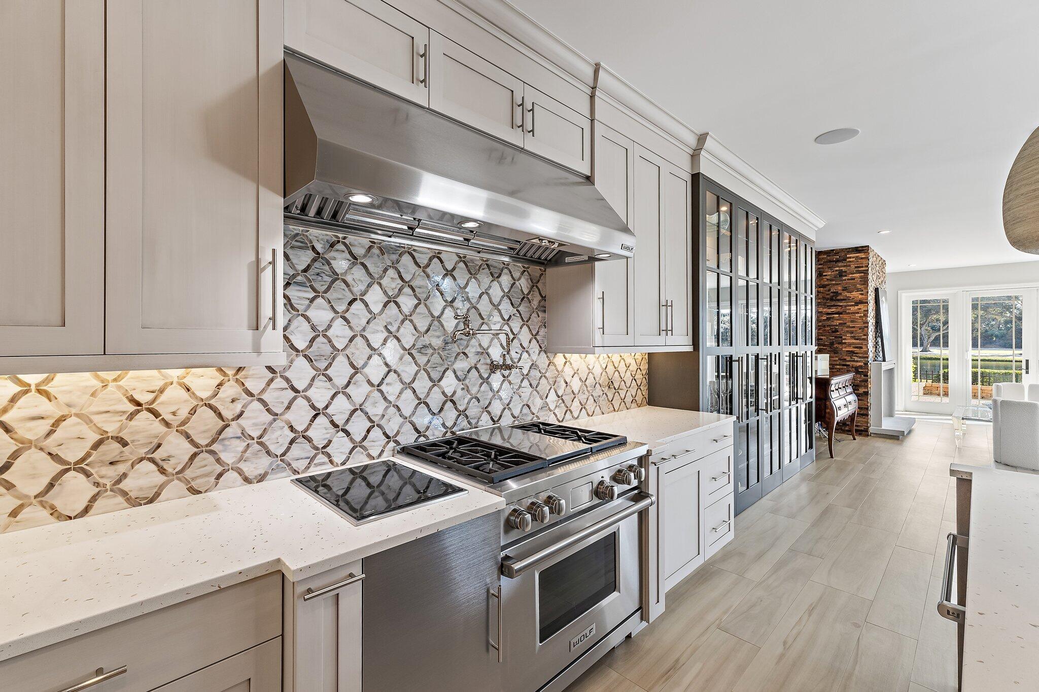 12092 Southeast Birkdale Run Jupiter, FL 33469 - Photo 24 of 53 a kitchen with a stove and a wooden cabinets