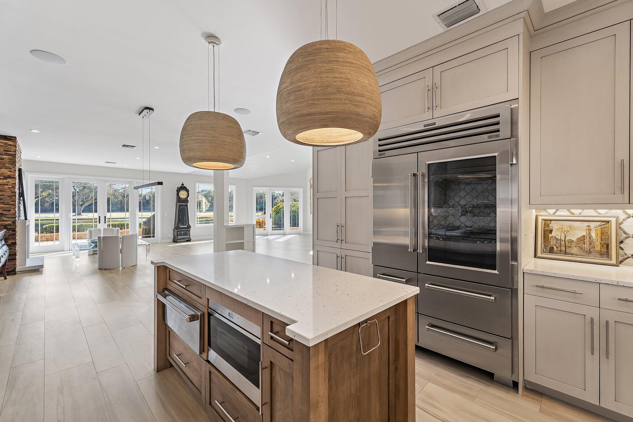 12092 Southeast Birkdale Run Jupiter, FL 33469 - Photo 25 of 53 a kitchen with stainless steel appliances granite countertop a stove and a microwave