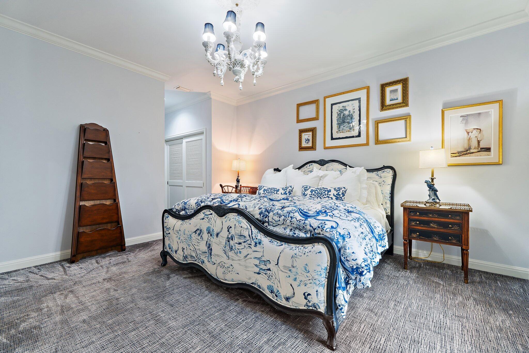 12092 Southeast Birkdale Run Jupiter, FL 33469 - Photo 31 of 53 a bedroom with a bed and a chandelier