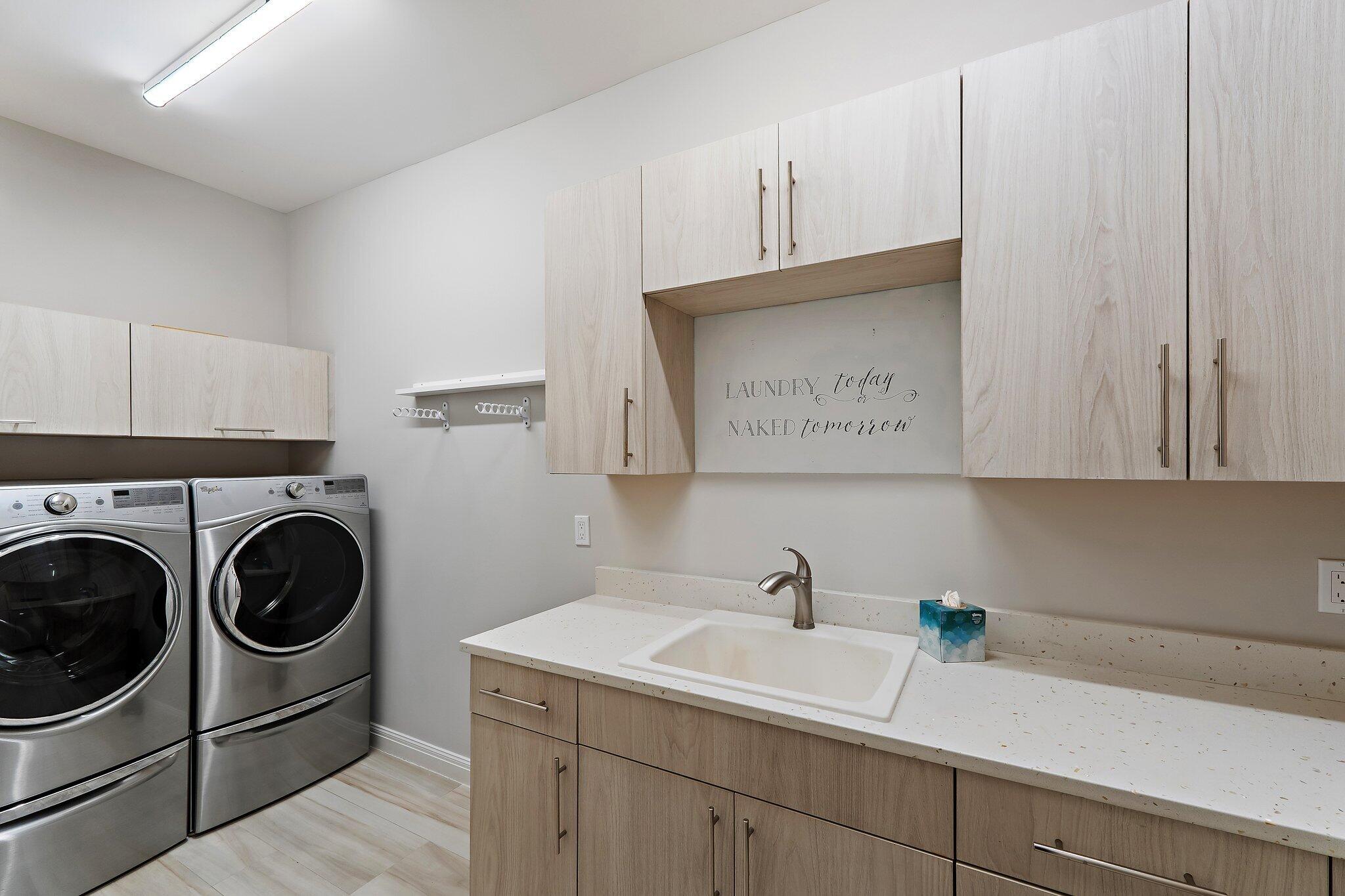 12092 Southeast Birkdale Run Jupiter, FL 33469 - Photo 38 of 53 a utility room with sink dryer and washer