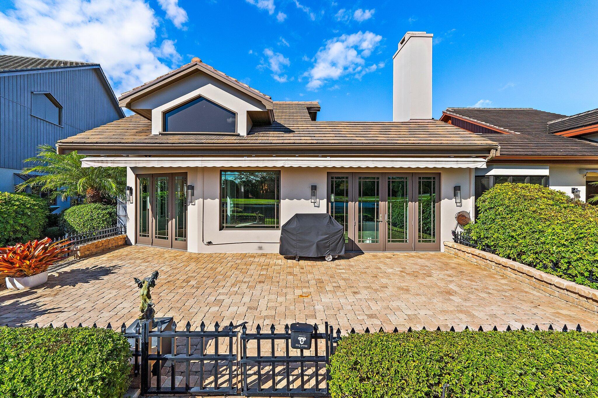 12092 Southeast Birkdale Run Jupiter, FL 33469 - Photo 40 of 53 a front view of a house with glass top table and chairs