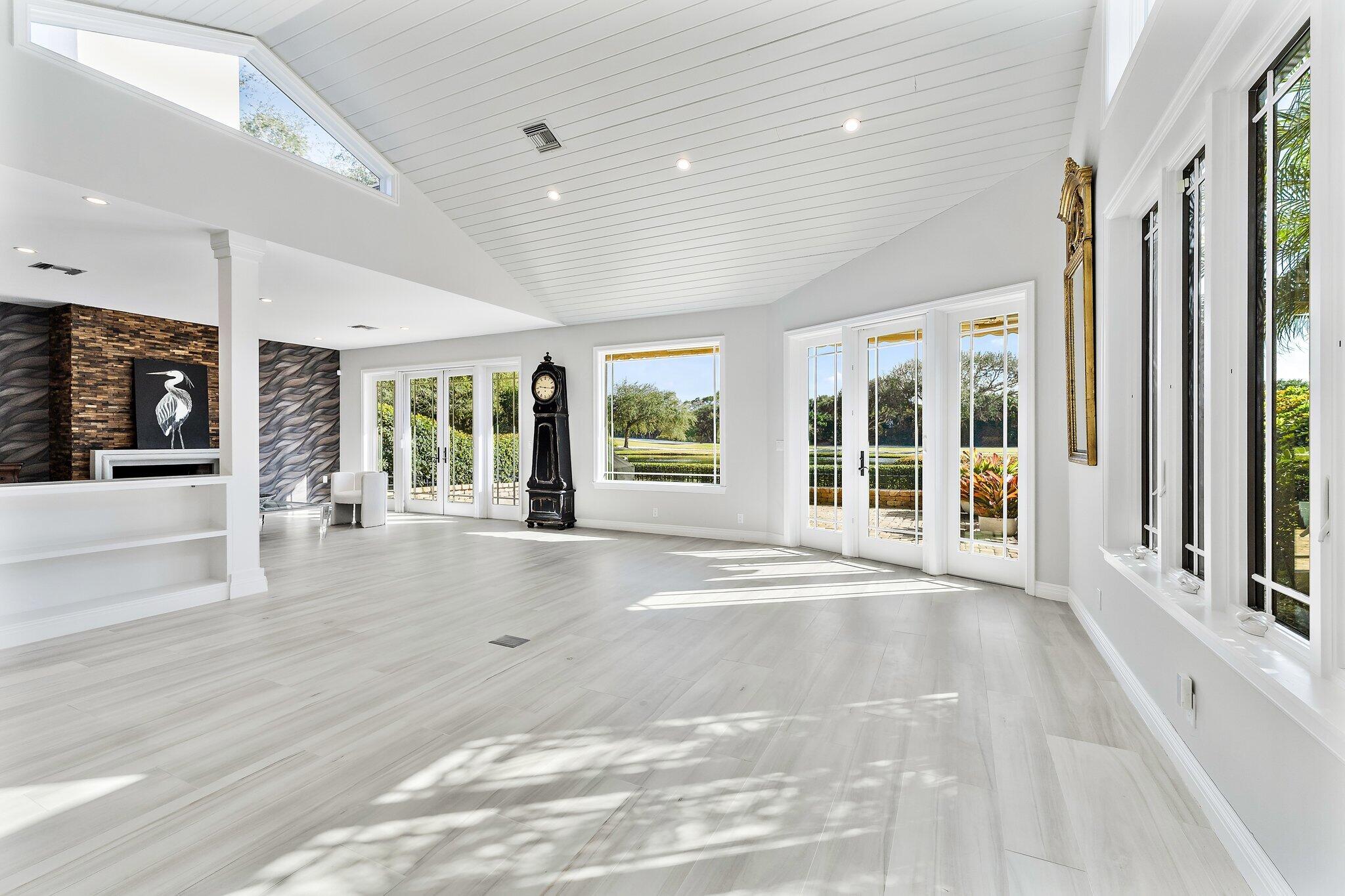 12092 Southeast Birkdale Run Jupiter, FL 33469 - Photo 9 of 53 a view of an entryway with wooden floor and windows