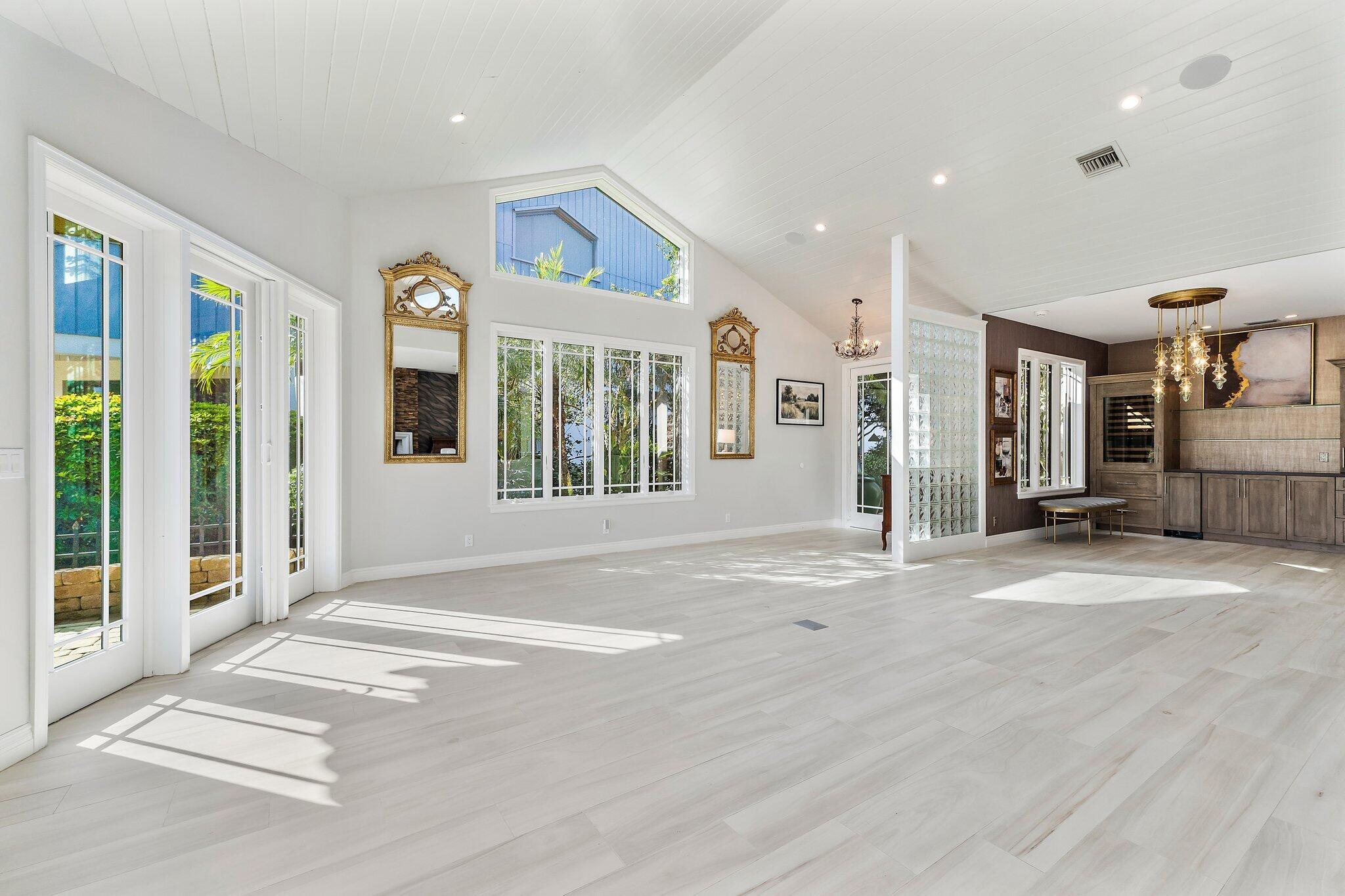 12092 Southeast Birkdale Run Jupiter, FL 33469 - Photo 10 of 53 a view of a hall with wooden floor and a porch