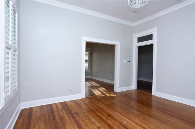 an empty room with wooden floor and closet