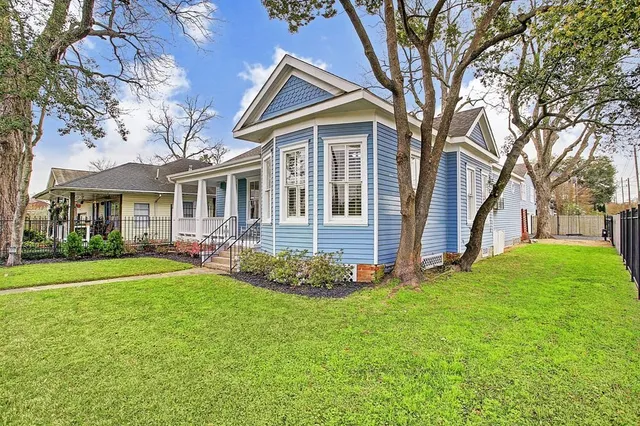 a front view of a house with a garden