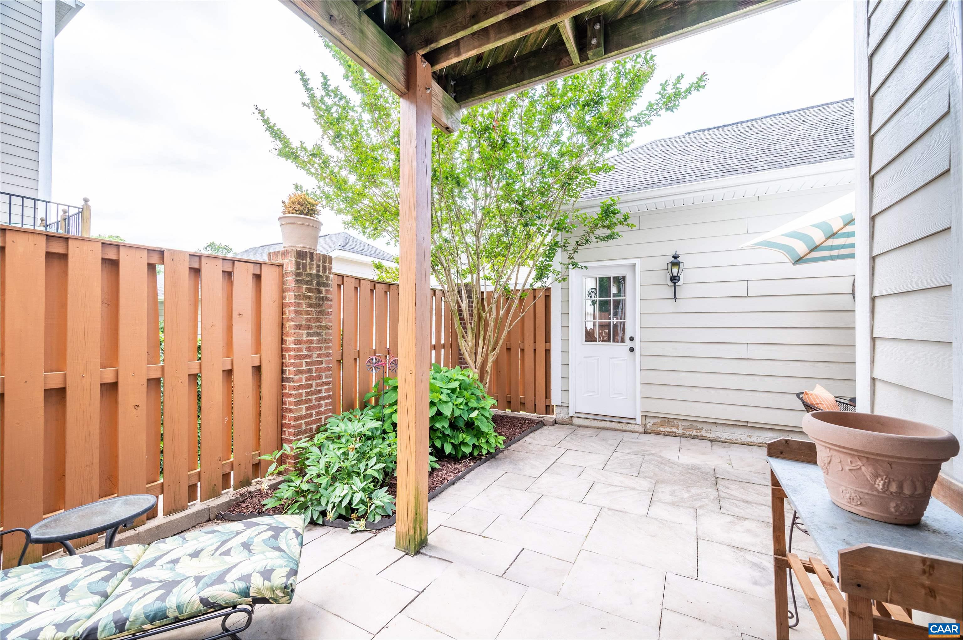 719 Rainier Road Charlottesville, VA 22903 - Photo 6 of 41 a backyard of a house with potted plants and couches
