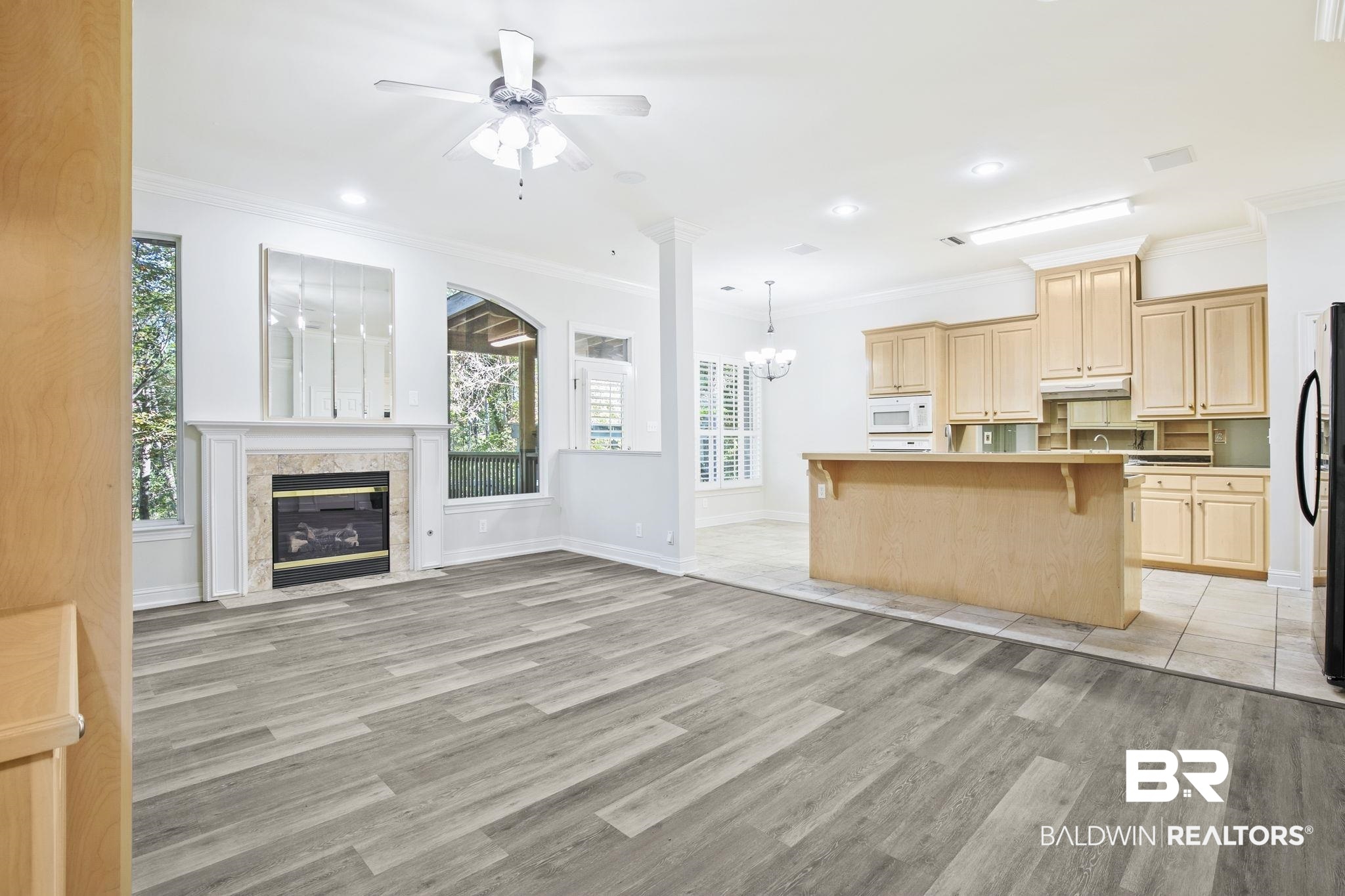 13 Bugle Retreat Daphne, AL 36527 - Photo 5 of 40 Kitchen featuring a kitchen breakfast bar, ceiling fan with notable chandelier, white appliances, light hardwood / wood-style floors, and a kitchen island