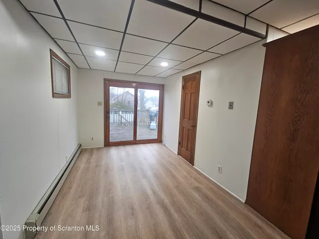 a view of hallway with wooden floor