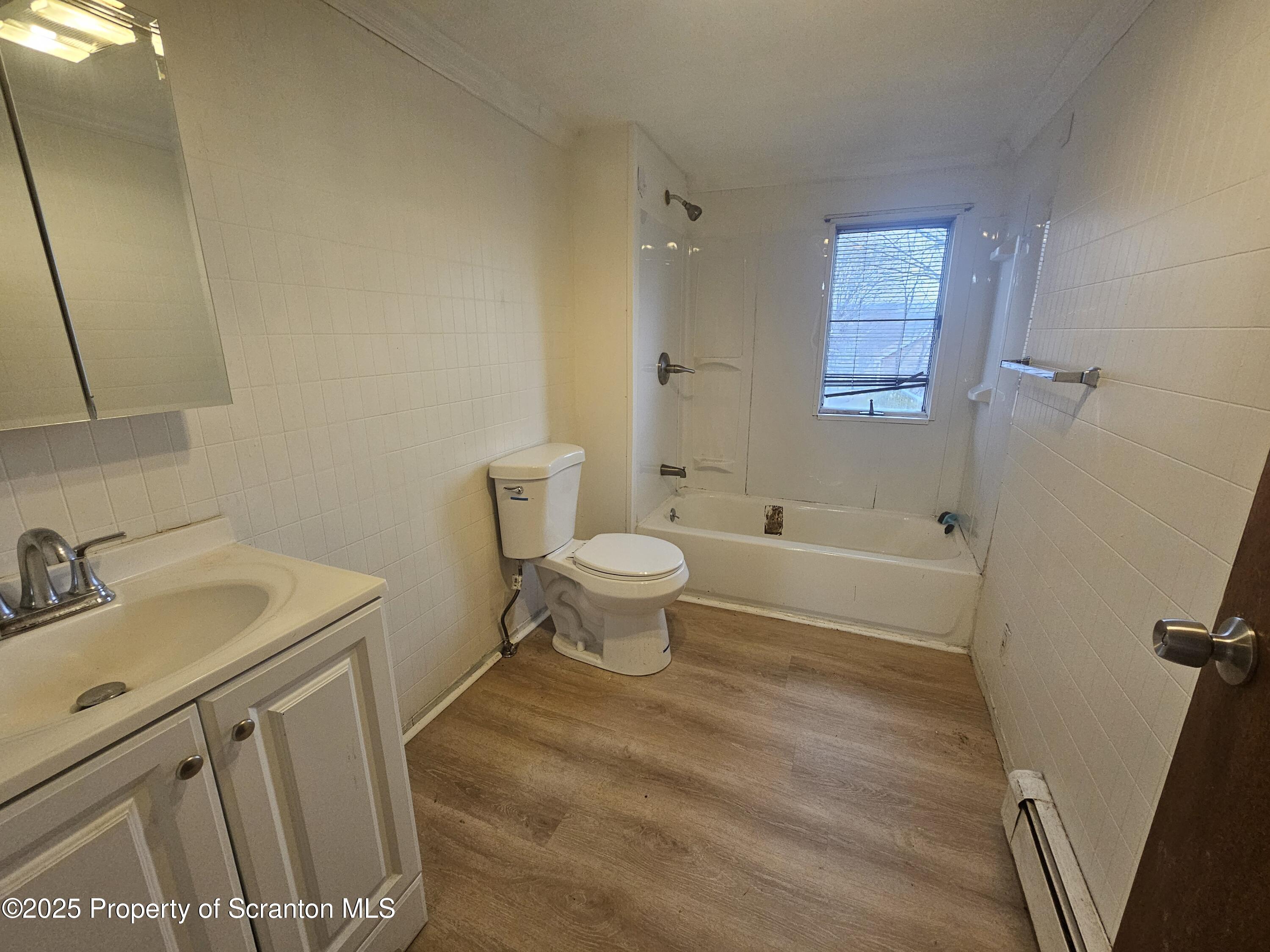328 4th Street Blakely, PA 18447 - Photo 6 of 13 a bathroom with a sink a toilet and shower
