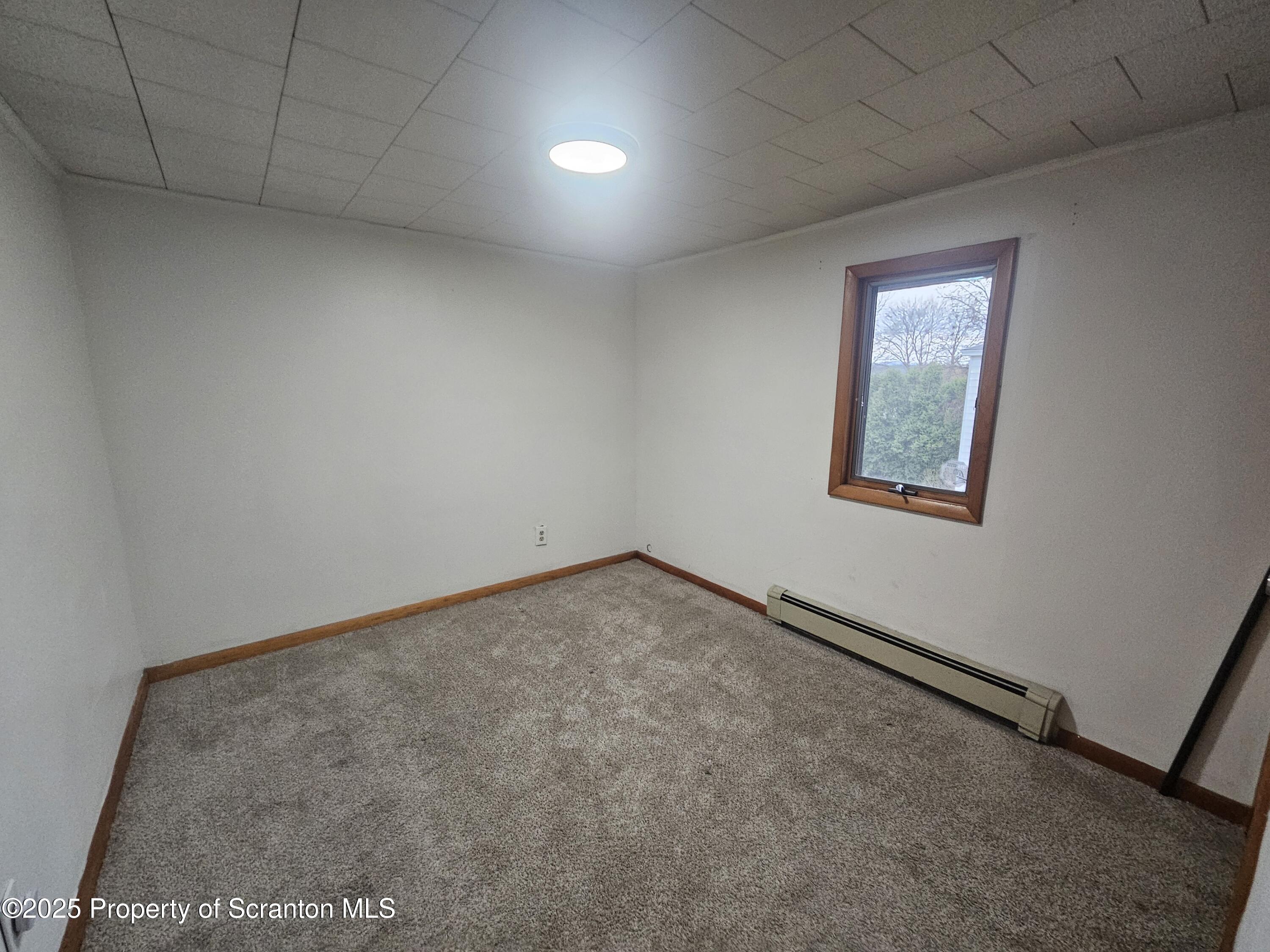 328 4th Street Blakely, PA 18447 - Photo 9 of 13 an empty room with a workbench