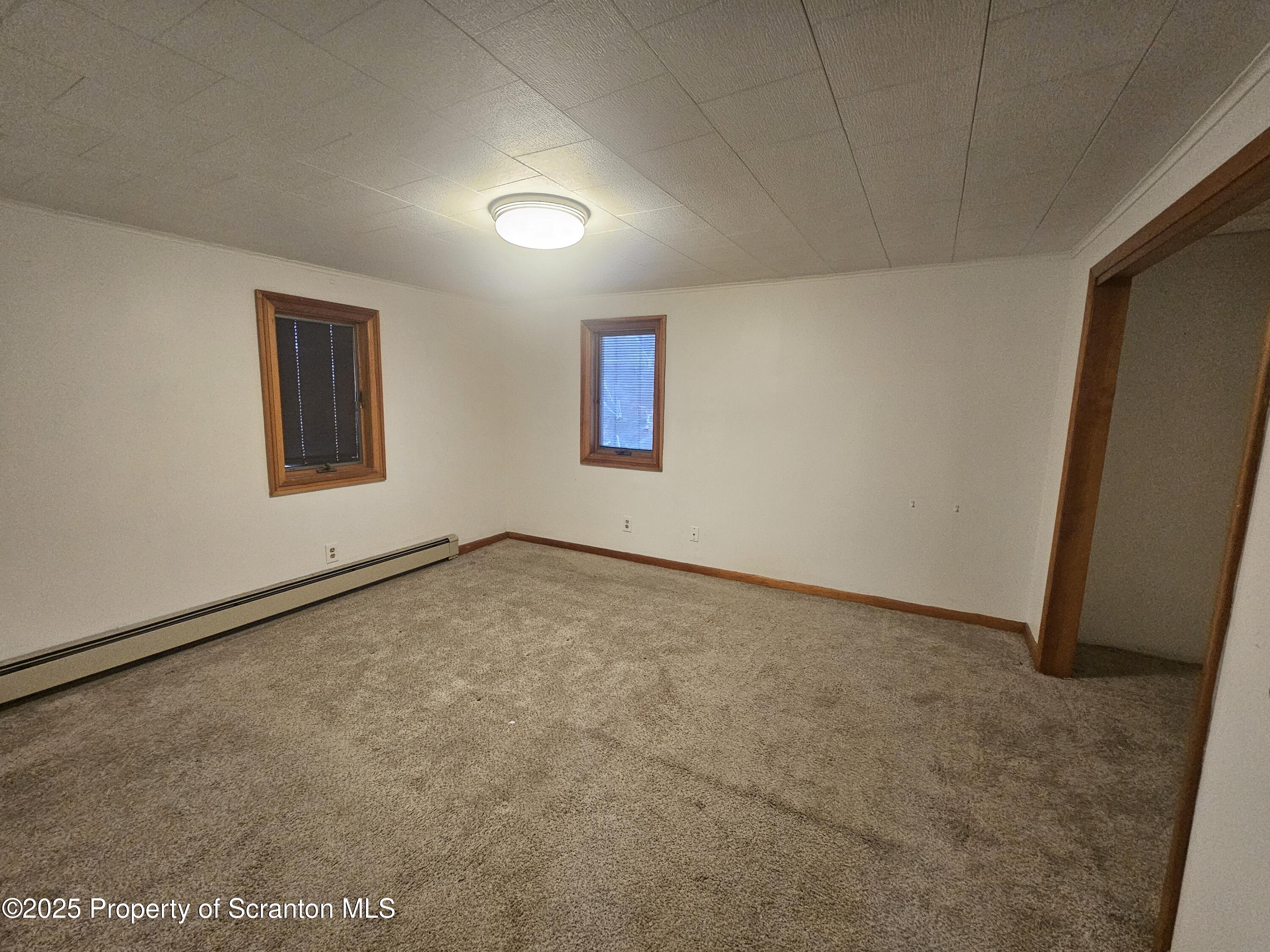 328 4th Street Blakely, PA 18447 - Photo 10 of 13 an empty room with a workbench
