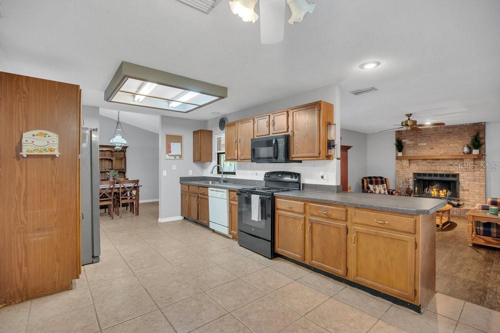 90 Sundown Road DeBary, FL 32713 - Photo 11 of 36 a kitchen with a refrigerator and a sink